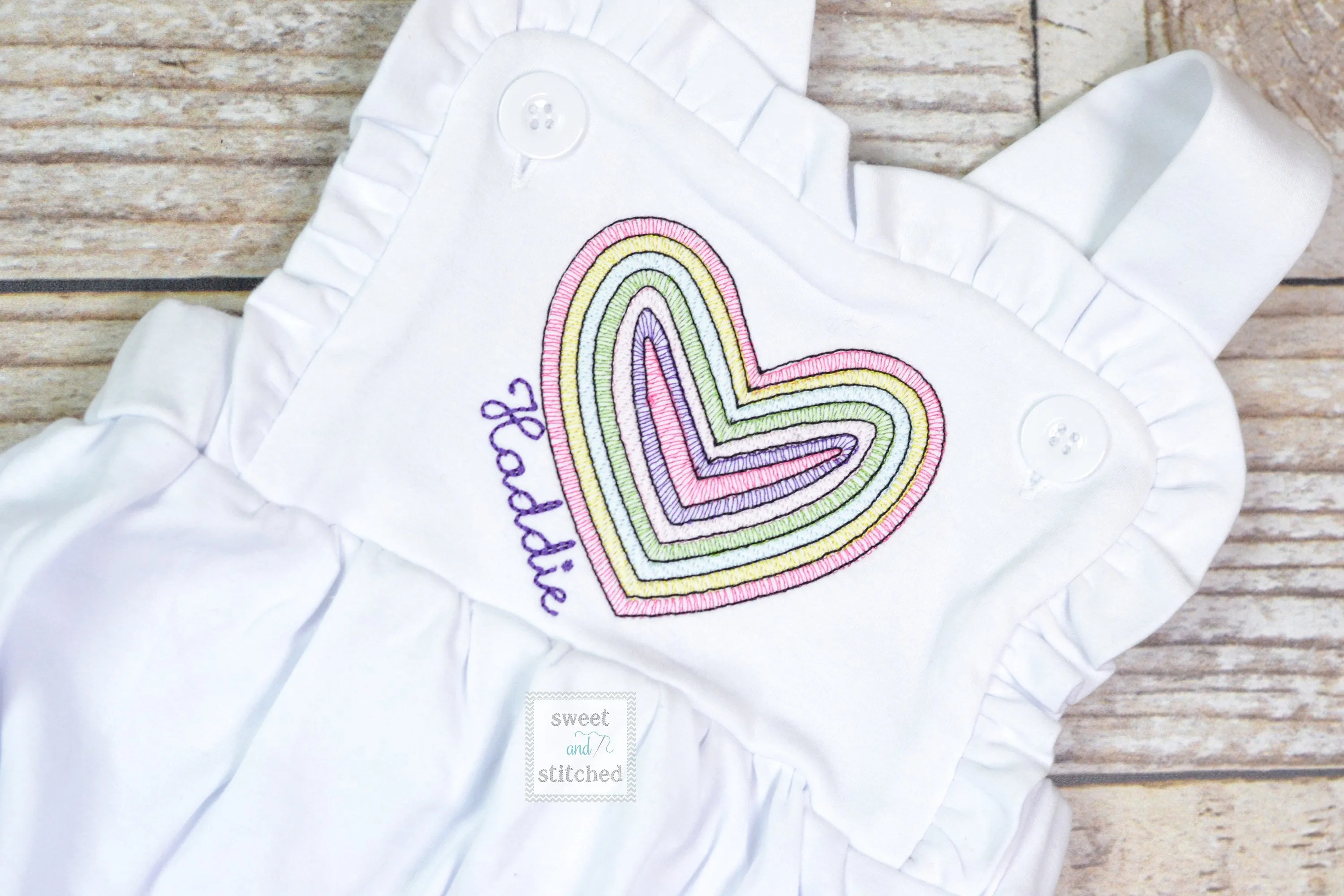 Monogrammed baby girl Valentine's outfit with vintage rainbow heart design